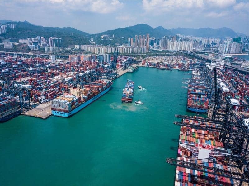 Aerial view of a commercial port with container terminals, shipping berths, and logistics infrastructure for Drone LiDAR terrain mapping and site planning.